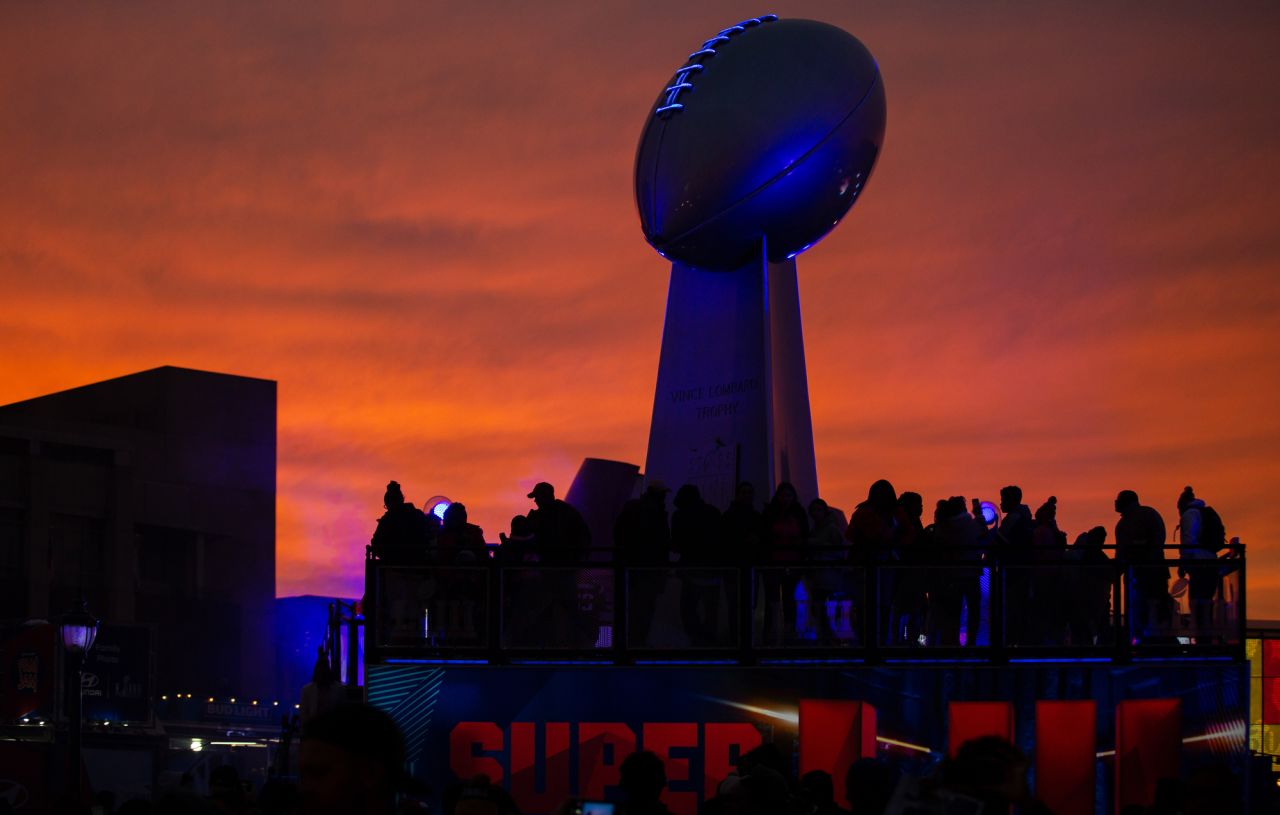 The sun sets over a giant interactive sculpture of the NFL's Lombardi Trophy in Atlanta's Centennial Park on Sunday.