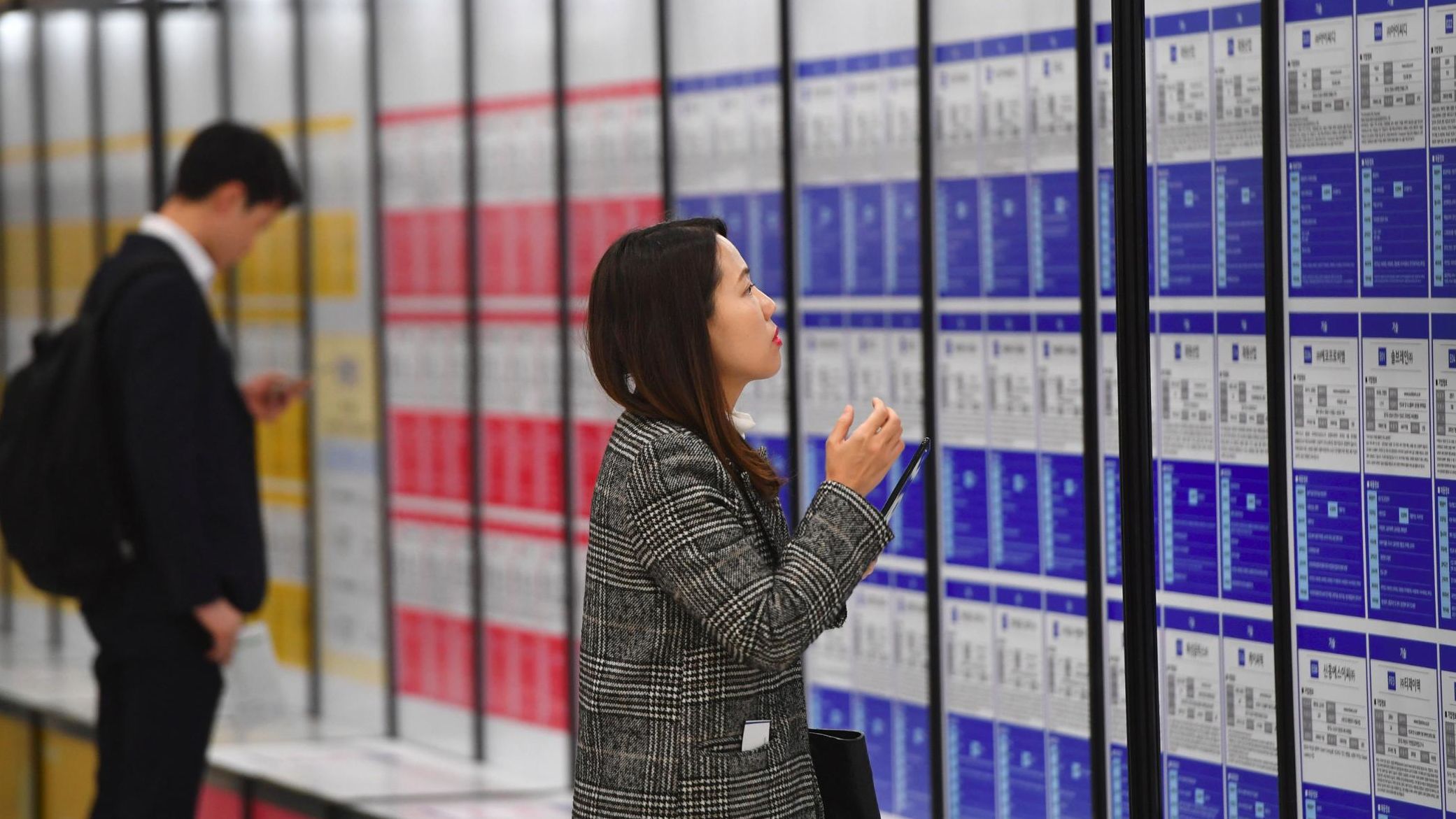 A woman looks at notices during a jobs fair in Seoul. Women often struggle to find a foothold in South Korea's male-dominated corporate culture and a series of firms have been caught using sexist recruitment targets to keep it that way.