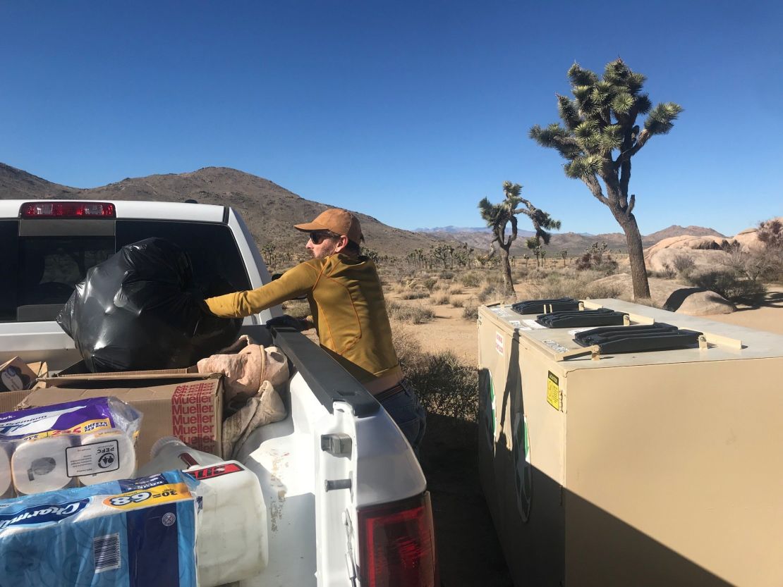 A volunteer clears trash at Joshua Tree National Park.