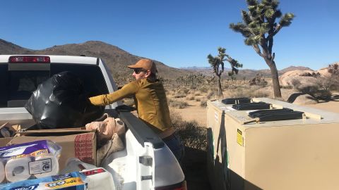 A volunteer clears trash at Joshua Tree National Park.