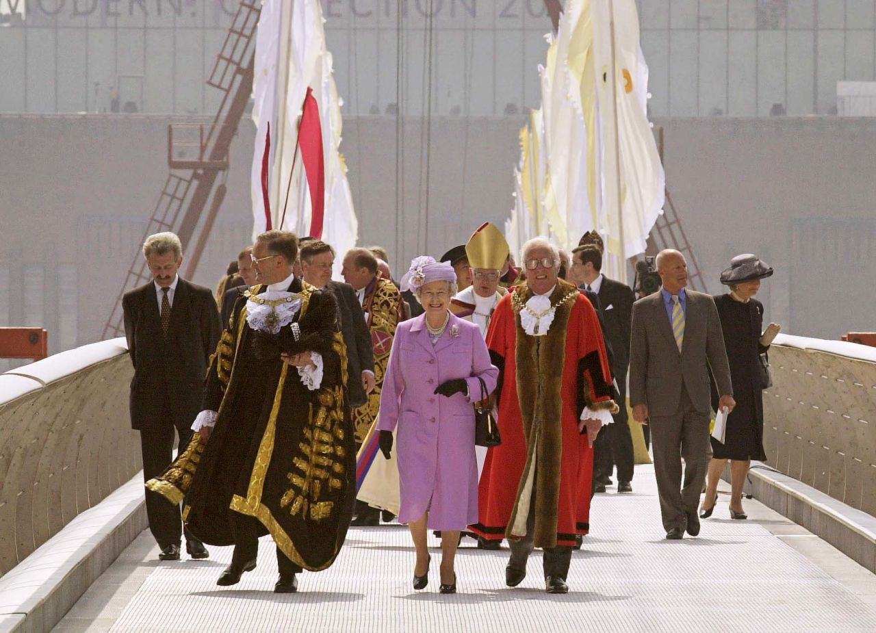 The Queen walks the Millennium Bridge across the River Thames in 2000, before dedicating it in a ceremony. 