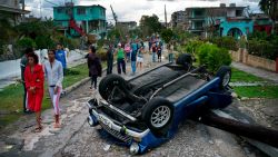 A car overturned by a tornado lays smashed on top of a street pole in Havana, Cuba, Monday, Jan. 28, 2019. A tornado and pounding rains smashed into the eastern part of Cuba's capital overnight, toppling trees, bending power poles and flinging shards of metal roofing through the air as the storm cut a path of destruction across eastern Habana. (AP Photo/Ramon Espinosa)