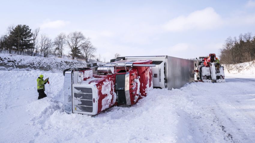 Tow truck personnel work to remove an overturned semi in the median of Interstate 90 at mile marker 218 near the U.S. Highway 52 exit Monday, Jan. 28, 2019, southeast of Rochester, Minn. According to Sgt. Troy Christianson, with the Minnesota State Patrol, the semi was eastbound and went straight off the gradual curve into the median because of blowing snow. Sgt. Christianson said there were no injuries in the crash. (Joe Ahlquist/The Rochester Post-Bulletin via AP)