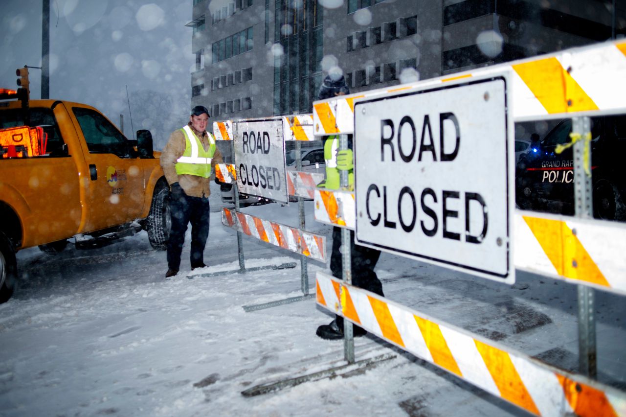 City workers put up a road-closed sign in Grand Rapids, Michigan, on January 28.