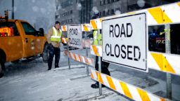 City workers put up a road closed sign on the Michigan Street hill in Grand Rapids, Mich., Monday, Jan. 28, 2019. Snow made travel dangerous is many areas of the state. Heavy snow and gusting winds created blizzard-like conditions Monday across parts of the Midwest, prompting officials to close hundreds of schools, courthouses and businesses, and ground air travel. (Neil Blake/The Grand Rapids Press via AP)