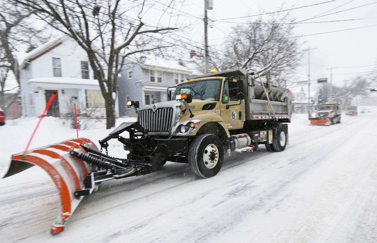 Snowplows clear Williamson Street in Madison, Wisconsin.