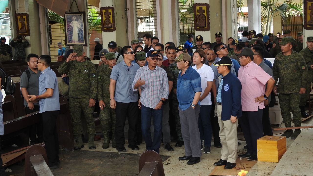 Philippine President Rodrigo Duterte accompanied by Defense Secretary Delfin Lorenzana inspect the damaged area of the church in Jolo.