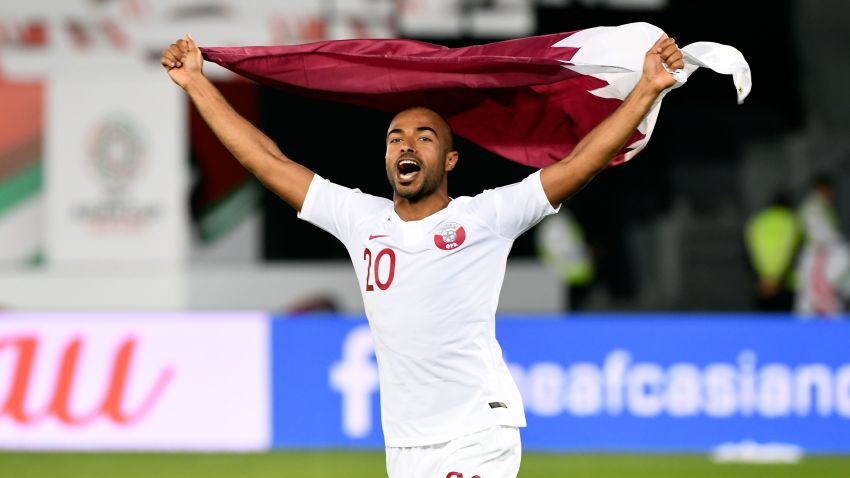 Qatar's midfielder Ali Yahya celebrates the win with the national flag during the 2019 AFC Asian Cup quarter-final football match between South Korea and Qatar at Zayed Sports City in Abu Dhabi on January 25, 2019. (Photo by Roslan RAHMAN / AFP)        (Photo credit should read ROSLAN RAHMAN/AFP/Getty Images)