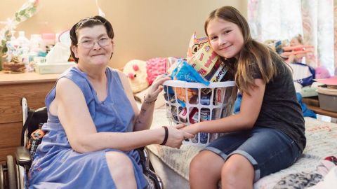 Ruby Kate Chitsey delivers a nursing home resident some of the items requested through "Three Wishes."