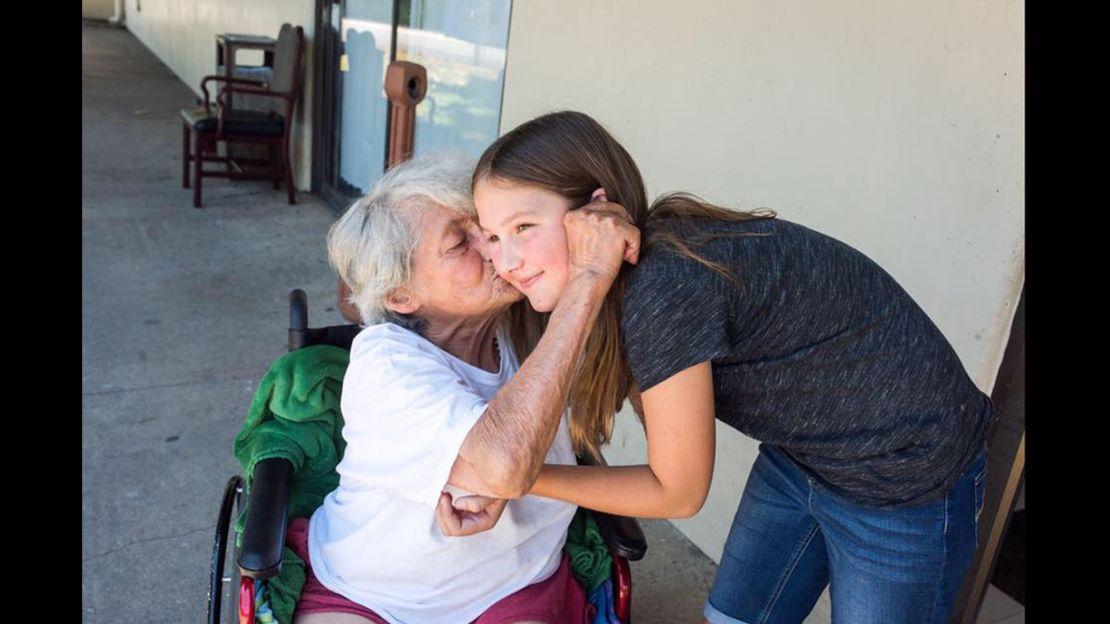 11-year-old Ruby Kate Chitsey gets kisses from a nursing home resident. 