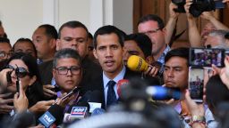 Venezuela's National Assembly head and self-proclaimed "acting president" Juan Guaido, talks to journalists upon arrival at the National Assembly in Caracas on January 29, 2019. - Venezuela's Attorney General Tarek William Saab asked the Supreme Court on Tuesday to bar self-proclaimed acting president and opposition leader Juan Guaido from leaving the country and to freeze his assets. (Photo by Yuri CORTEZ / AFP)        (Photo credit should read YURI CORTEZ/AFP/Getty Images)