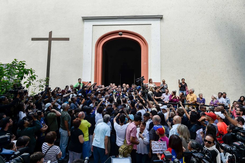 Guaido speaks to reporters after attending Mass in Caracas on Sunday, January 27.