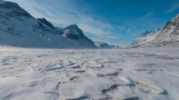 BAFFIN ISLAND, CANADA - APRIL 16:  Mountains surround the frozen Weasel River through Akshayuk Pass, in Auyuittuq National Park on April 16, 2017 on Baffin Island, Canada. (Photo by Christopher Morris - Corbis/Getty Images)