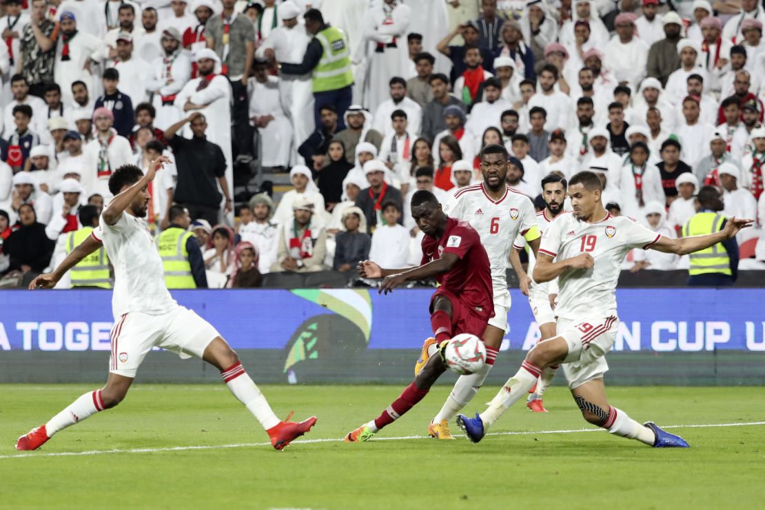 Qatar's forward Almoez Ali (C) shoots to score during his side's win over UAE.