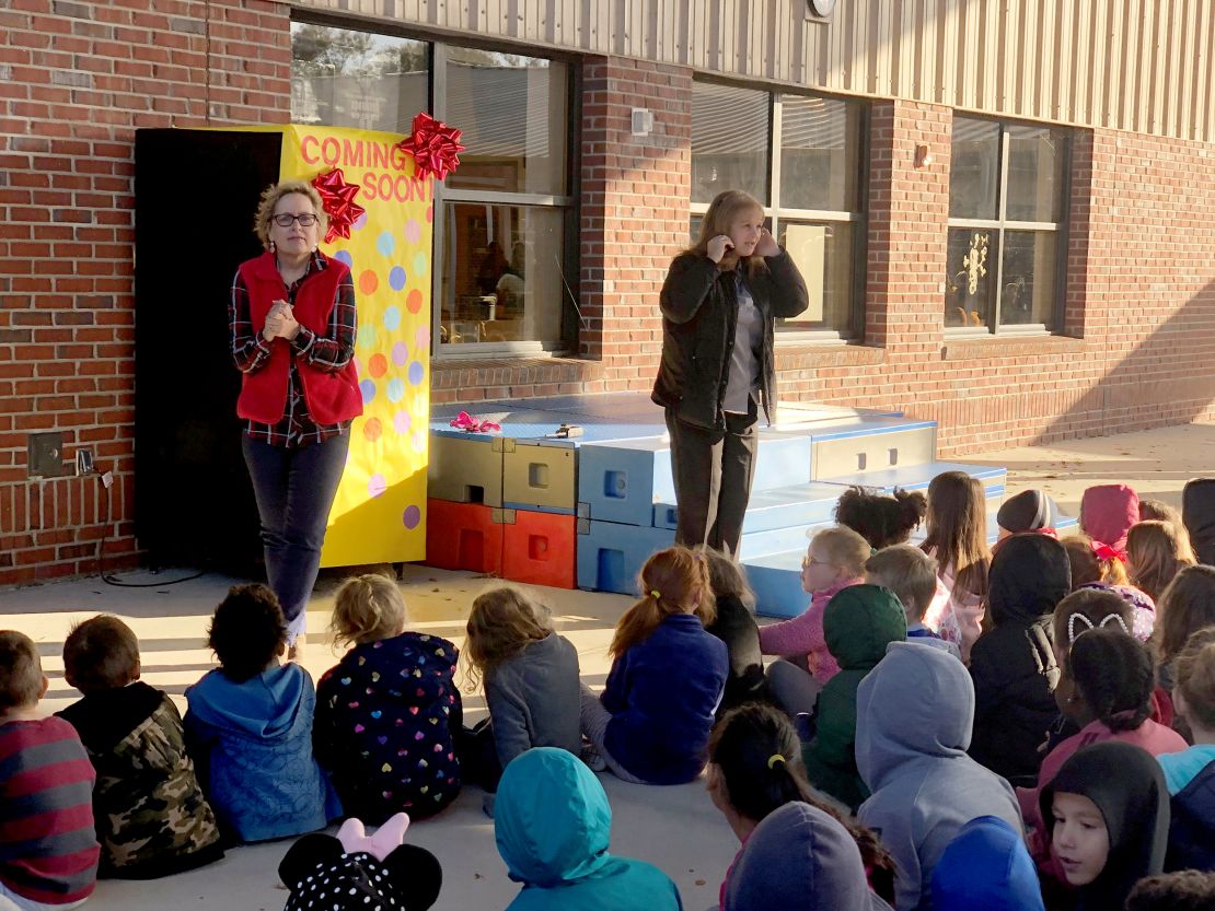 The school's principal and media specialist held a pep rally to unveil the new vending machine.