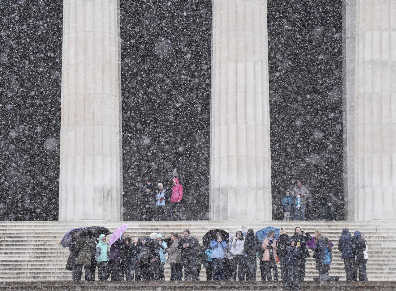 A tour group visits the Lincoln Memorial as snow blankets Washington on January 29.