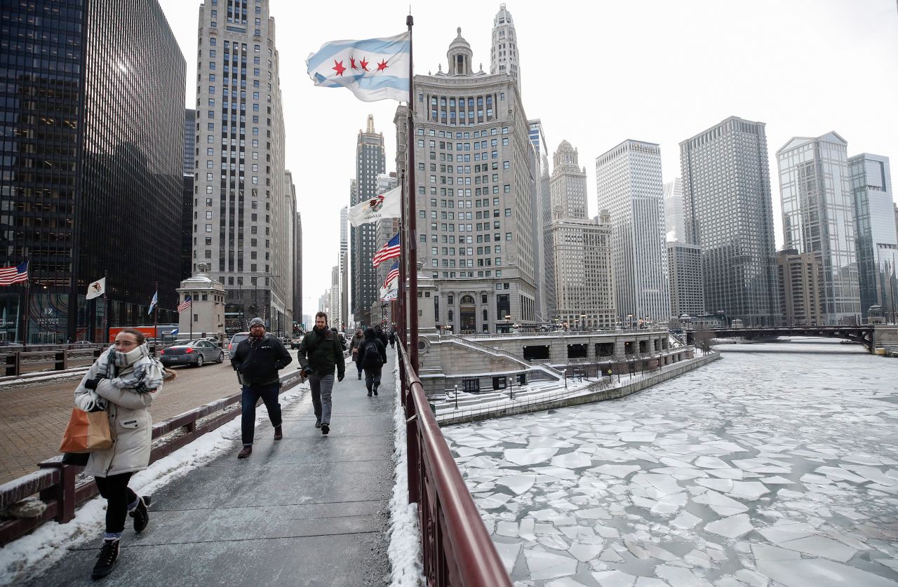 Pedestrians walk along Michigan Avenue in Chicago, above the frozen Chicago River, on January 29.