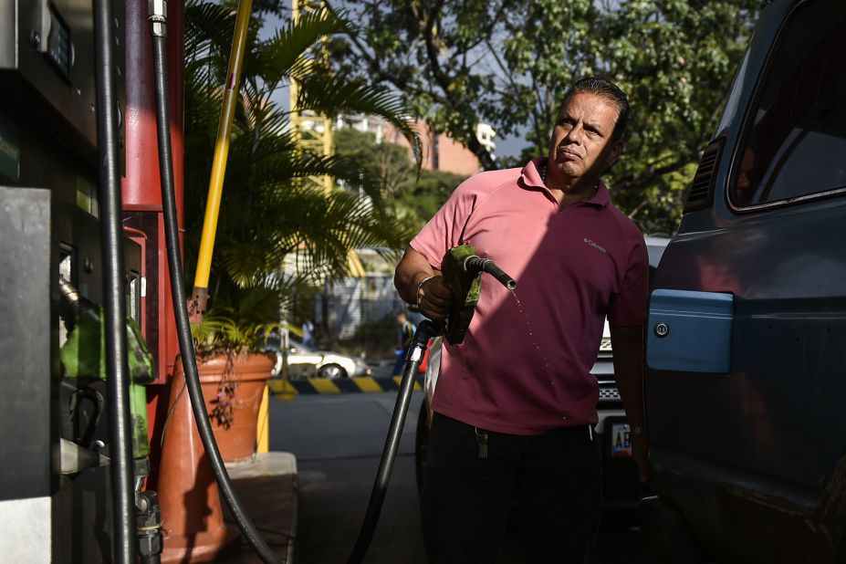 A man pumps fuel at a gas station in Caracas on January 29. A day earlier, the United States announced sanctions against Venezuela's state oil company, Petroleos de Venezuela, S.A.