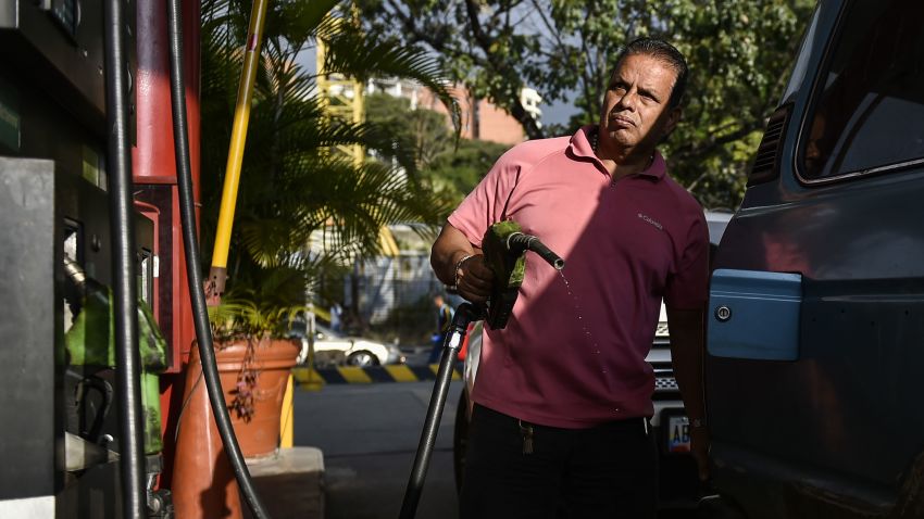 A man pumps fuel at a gas station in Caracas, on January 29, 2019. - The United States announced sanctions against Venezuela's state oil company Monday in a coordinated effort with the main opposition leader to cripple embattled President Nicolas Maduro's power base. (Photo by Luis ROBAYO / AFP)        (Photo credit should read LUIS ROBAYO/AFP/Getty Images)