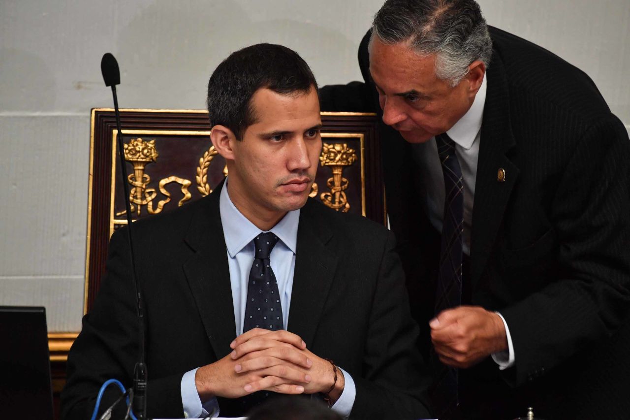 Guaido listens to deputy Rafael Veloz during a session at the National Assembly in Caracas on January 29. The Assembly met to debate a legal framework for creating a transitional government and calling new elections. Simultaneously, Venezuela's attorney general asked the Supreme Court to freeze Guaido's assets and bar him from leaving the country.