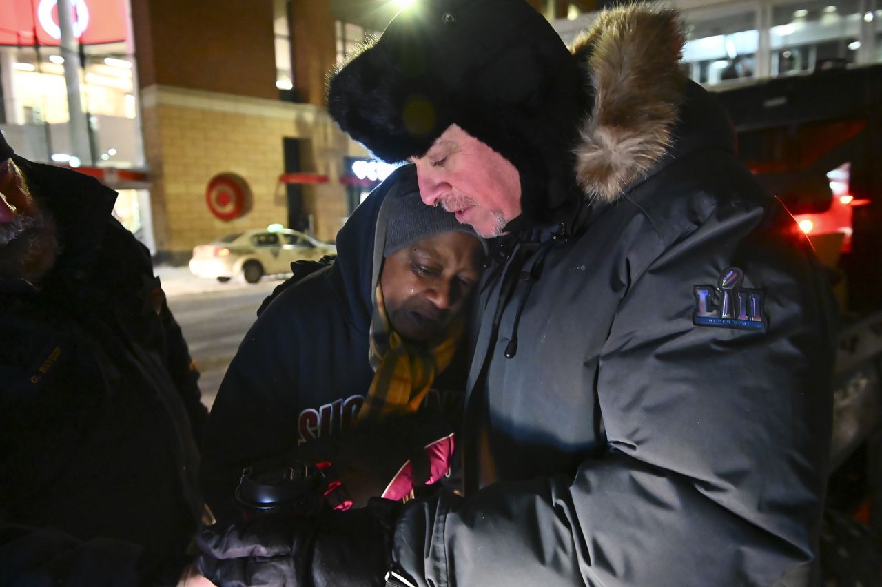 Pastor John Steger of Grace In The City church embraces Jearline Cyrus, a homeless woman, while delivering cold-weather provisions in downtown Minneapolis on Tuesday, January 29.