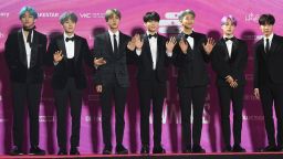 In this picture taken on January 15, 2019, South Korean boy band BTS, also known as the Bangtan Boys, pose on the red carpet at the 28th Seoul Music Awards in Seoul. - The K-pop phenomenon BTS is estimated to generate nearly 4 billion USD a year for the South Korean economy, but the boyband's seven members will still have to perform nearly two years of military service, in contrast to the likes of Tottenham Hotspurs striker Son Heung-min who had been granted a controversial exemption. (Photo by Jung Yeon-je / AFP) / TO GO WITH AFP STORY  SKOREA-DEFENCE-SOCIAL-ENTERTAINMENT,FOCUS BY KANG JIN-KYU        (Photo credit should read JUNG YEON-JE/AFP/Getty Images)