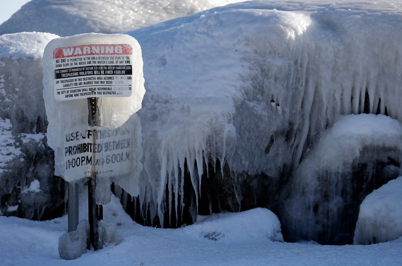 A warning sign is covered by ice at Clark Square Park in Evanston, Illinois.