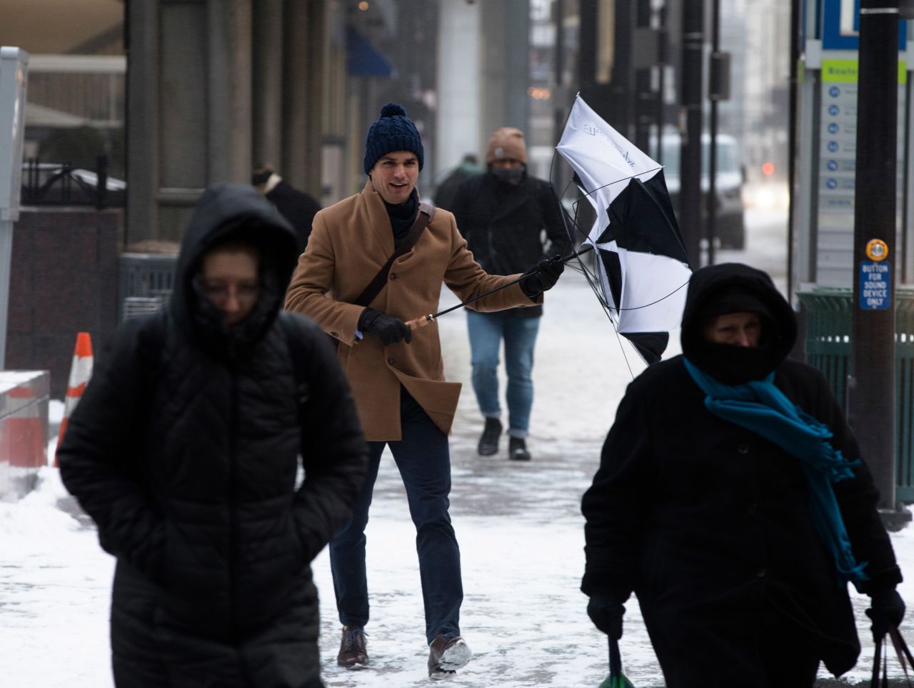 Pedestrians walk through a winter storm in downtown Cincinnati on January 30.