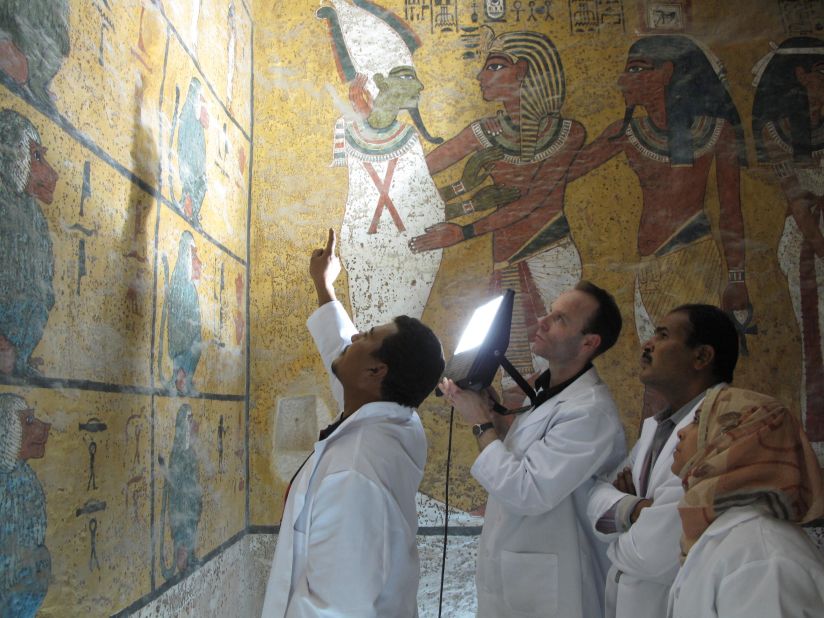 Undertaking a visual examination of the wall painting in the burial chamber in February 2009. Scientists compared photographs taken in the 1920s with the current condition of the paintings, showing there was no change in the spots.