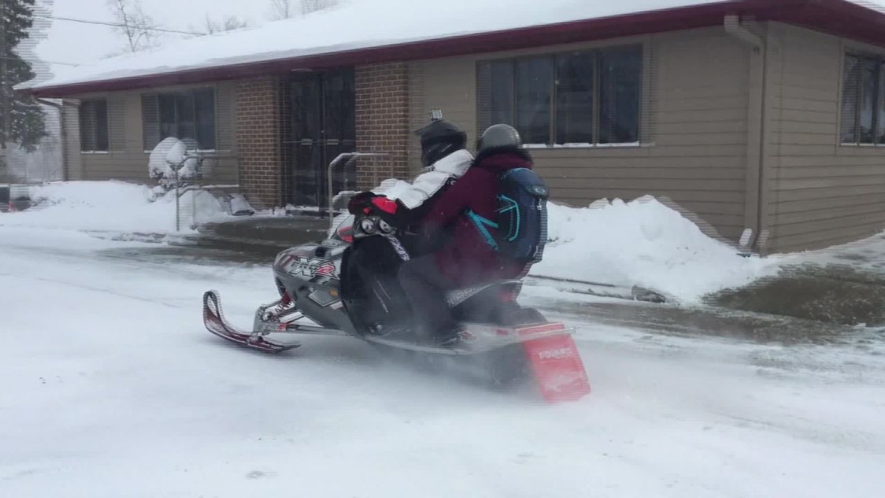 A Michigan pharmacist jumped on a snowmobile to deliver medicine to customers.  