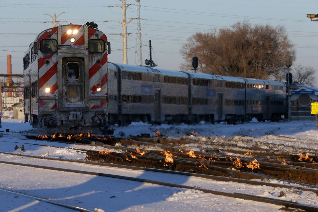 A train travels in Chicago as a gas-fired switch heater on the rails keeps the ice and snow off switches. 