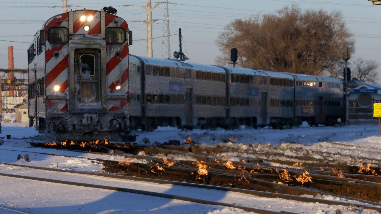 A train travels in Chicago as a gas-fired switch heater on the rails keeps the ice and snow off switches.