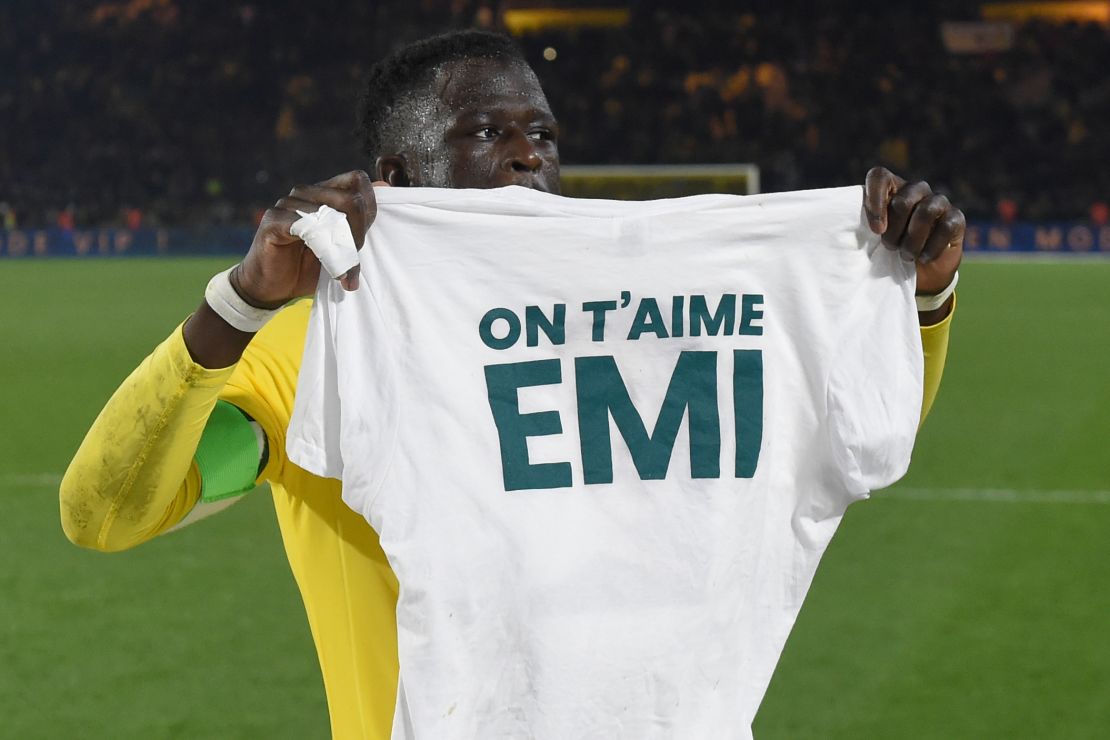 Nantes defender Abdoulaye Toure holds a shirt which reads 'We love you Emiliano.'