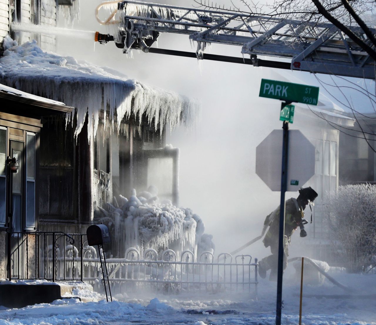 Firefighters in St. Paul, Minnesota, work at the scene of a house fire on January 30.