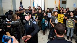 UNITED STATES - DECEMBER 10: Capitol Police move press and protesters back as protesters with the Sunrise Movement protest in House Minority Leader Nancy Pelosi's office in the Cannon House Office Building demanding a clim ate deal from Democrats on Monday, Dec. 10, 2018. (Photo By Bill Clark/CQ Roll Call) (CQ Roll Call via AP Images)
