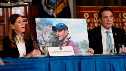 Linda Beigel Schulman, left, holds a photograph of her son Scott Beigel, who was killed by gun violence while speaking with New York Gov. Andrew Cuomo and gun safety advocates in the Red Room during a news conference at the state Capitol on Tuesday, Jan. 29, 2019, in Albany, N.Y. (AP Photo/Hans Pennink)