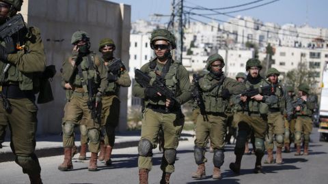 Israeli troops withdraw from Ramallah in the West Bank on December 15 after blowing up a house belonging to a Palestinian accused of killing an Israeli soldier.