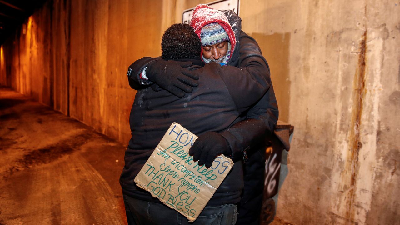 The Salvation Army's Richard S. Vargas hugs Alvin Henry during a cold wellness checkup in Chicago.
