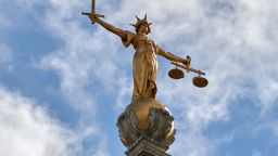 The "Lady of Justice", a 12 foot high, gold leaf statue is pictured on top of the dome of the Central Criminal Court, commonly referred to as The Old Bailey in central London on August 21, 2016.
Over the centuries the building has been periodically remodelled and rebuilt. The present building, though extensively rebuilt after being damaged by bombing in WWII, is that which was designed in the neo-Baroque style by Edward William Mountford and opened by King Edward VII in 1907. / AFP / NIKLAS HALLE'N        (Photo credit should read NIKLAS HALLE'N/AFP/Getty Images)