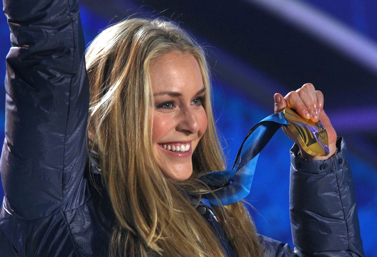 Vonn celebrates with her gold medal after the Olympic downhill.
