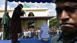 An 18-year-old Indonesian woman (centre R) is caned in public in Banda Aceh on January 31, 2019, as punishment for being caught cuddling with her boyfriend. - Two teenagers were whipped in Indonesia's Aceh province on January 31 after they were caught cuddling in public -- a crime under the conservative region's Islamic law. (Photo by CHAIDEER MAHYUDDIN / AFP) / The erroneous mention[s] appearing in the metadata of this photo by CHAIDEER MAHYUDDIN has been modified in AFP systems in the following manner: [An 18-year-old Indonesian woman] instead of [A 19-year-old Indonesian woman]. Please immediately remove the erroneous mention[s] from all your online services and delete it (them) from your servers. If you have been authorized by AFP to distribute it (them) to third parties, please ensure that the same actions are carried out by them. Failure to promptly comply with these instructions will entail liability on your part for any continued or post notification usage. Therefore we thank you very much for all your attention and prompt action. We are sorry for the inconvenience this notification may cause and remain at your disposal for any further information you may require.        (Photo credit should read CHAIDEER MAHYUDDIN/AFP/Getty Images)
