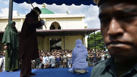 An Indonesian teen is caned in public in Banda Aceh as punishment for being caught cuddling with her boyfriend.