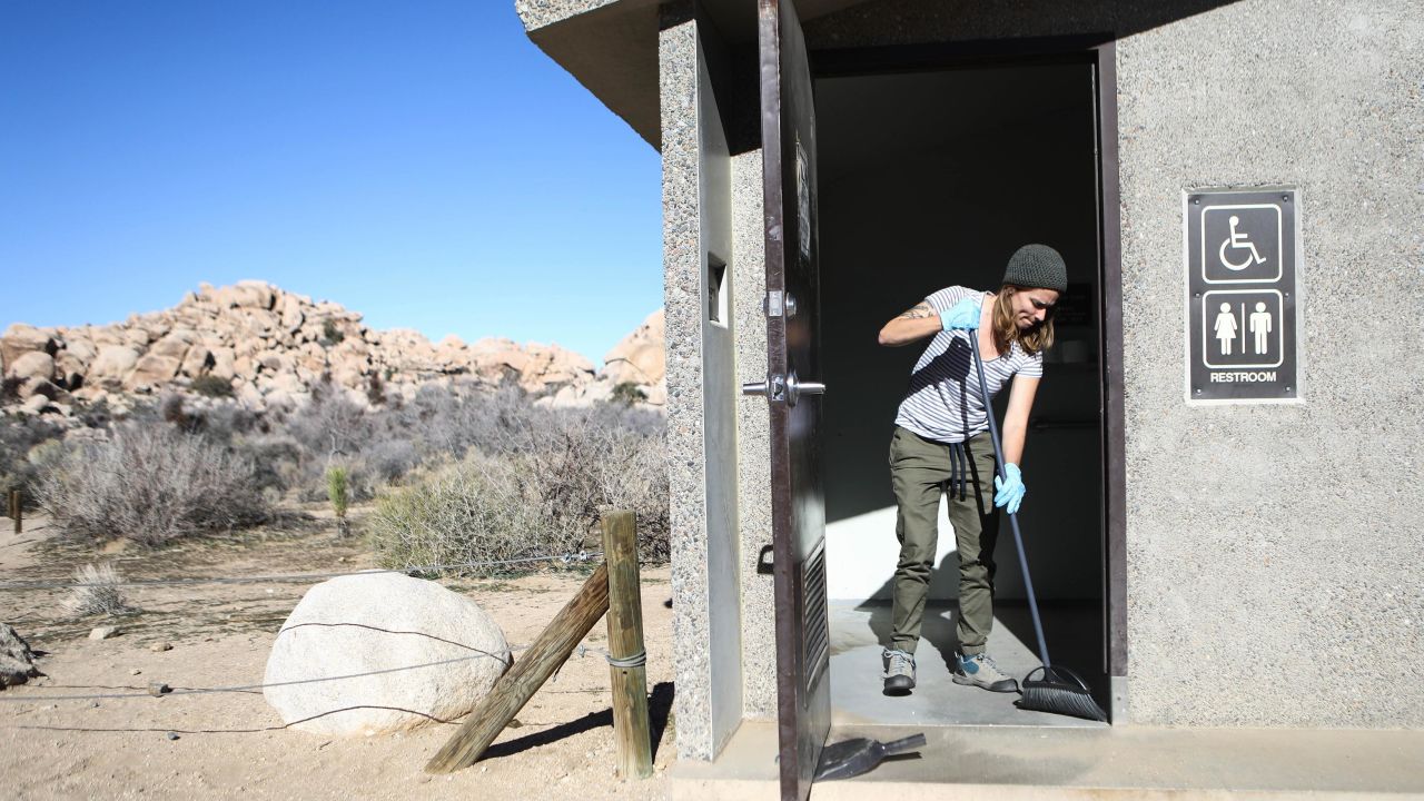 Volunteer Alexandra Degen cleans a restroom at Joshua Tree National Park on January 4, 2019