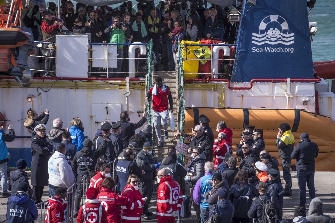 Migrants aboard the Sea-Watch 3 vessel disembark in the port of Catania on January 31.