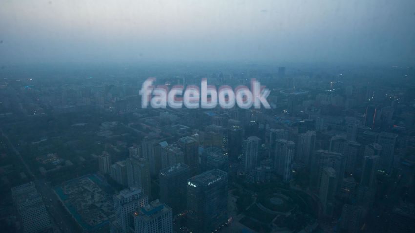 A photo taken on May 16, 2012 shows a computer screen displaying the logo of social networking site Facebook reflected in a window before the Beijing skyline. With investors hungry for Facebook shares ahead of a hotly anticipated offering, the social network unveiled a 25 percent increase in the number of shares to be sold at the market debut. AFP PHOTO / Ed Jones / AFP PHOTO / Ed Jones        (Photo credit should read ED JONES/AFP/Getty Images)
