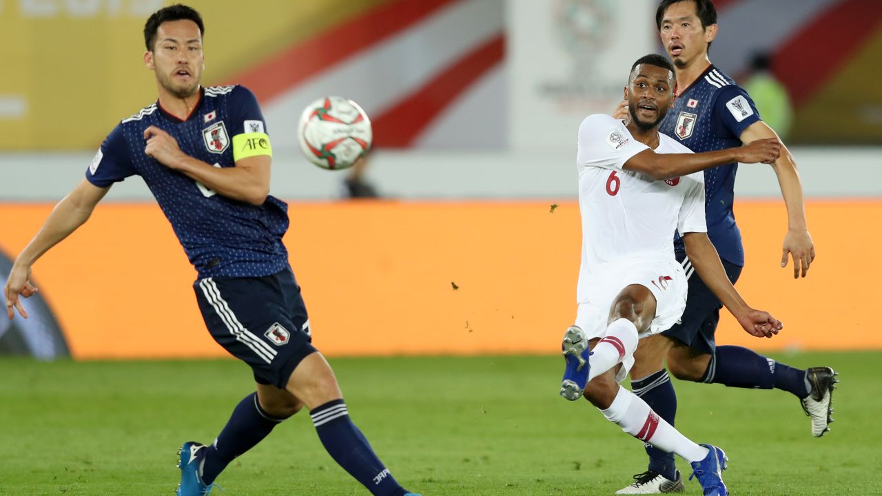 Abdelaziz Hatim of Qatar scores his team's second goal against Japan.