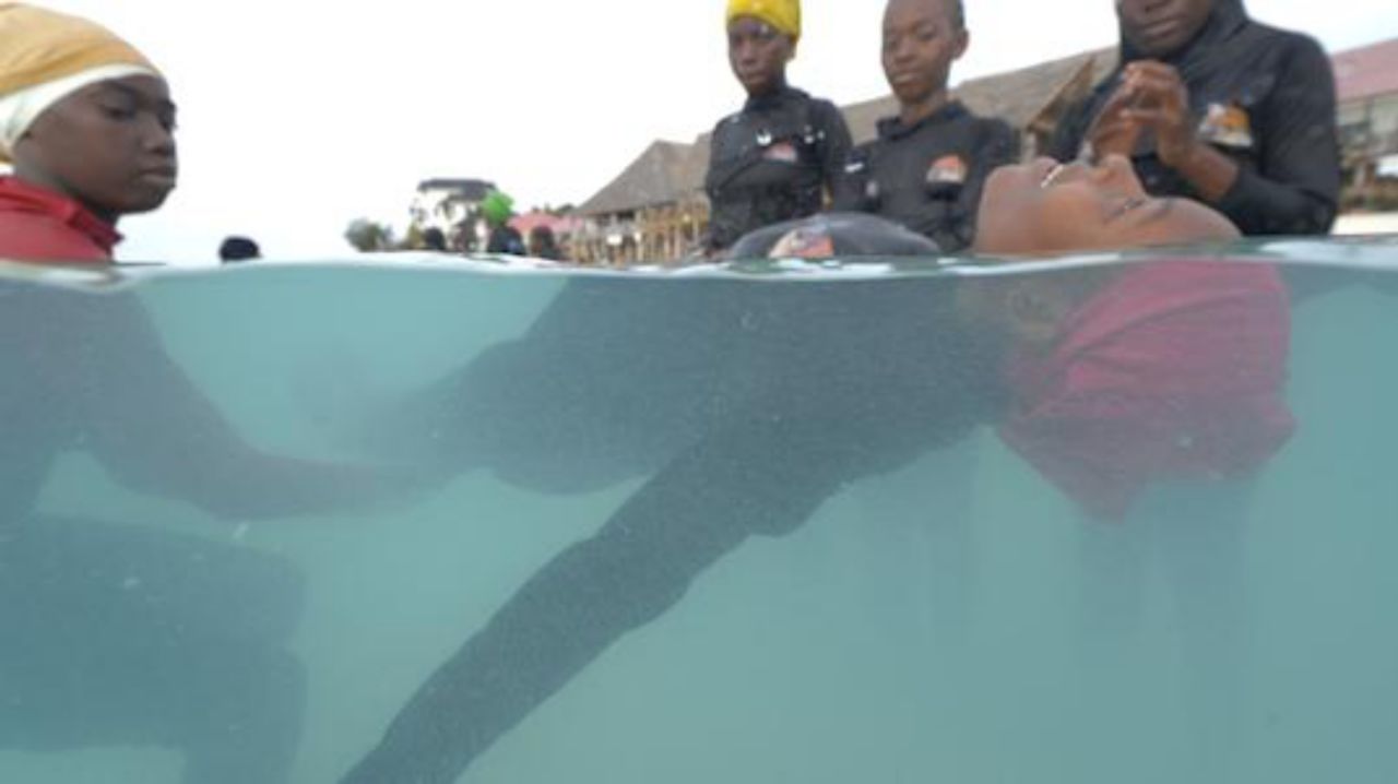 Girls learning swimming techniques in Zanzibar island