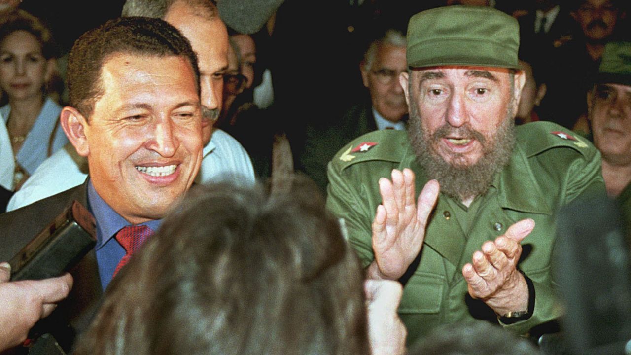 Venezuela's then-president-elect Hugo Chavez, flanked by then-Cuban leader Fidel Castro at the Jose Marti airport in Havana in 1999. 