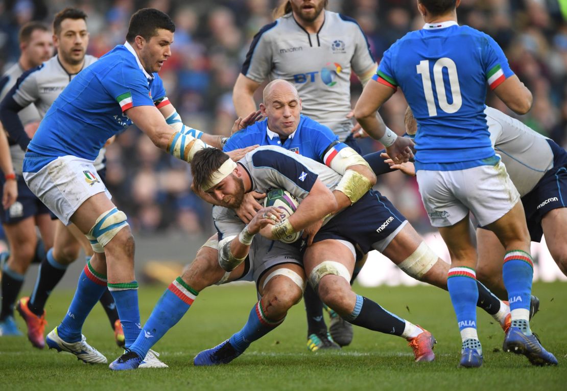 Record-breaker Sergio Parisse of Italy (center) tackles Ryan Wilson of Scotland during the Six Nations match between the teams on Saturday. 