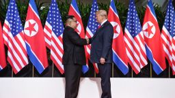 In this handout photo, North Korean leader Kim Jong-un (L) shakes hands with U.S. President Donald Trump (R) during their historic U.S.-DPRK summit at the Capella Hotel on Sentosa island on June 12, 2018 in Singapore.